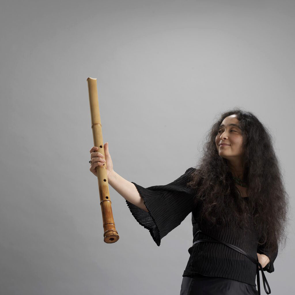 KikuDay-greay-background-holding-flute-2-1024x1024