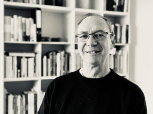 Teacher with books in the background